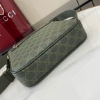 Crossbody bag with green GG-style monogram and long top zip detail