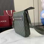 Crossbody bag three-quarter view with green GG-style monogram and wide shoulder strap