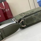 Crossbody bag strap attachment detail with green leather and silver hardware