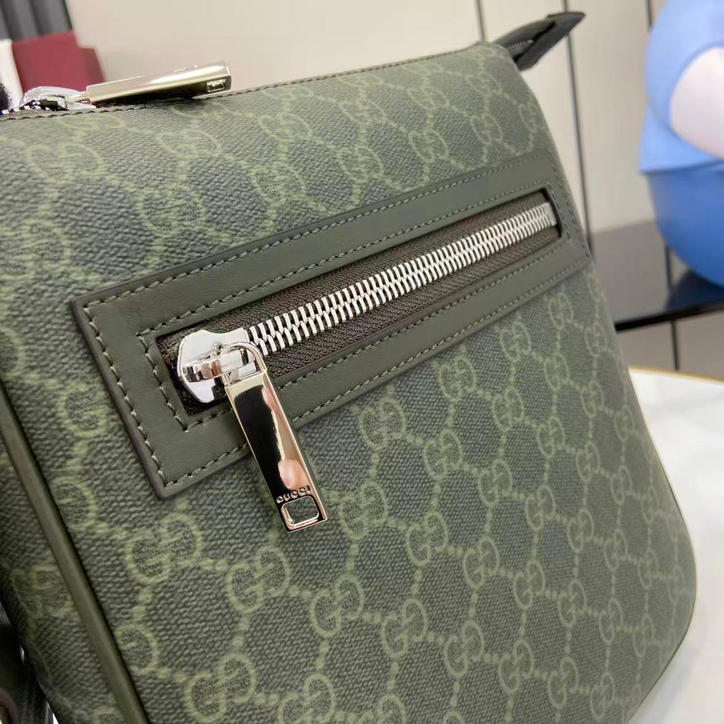 Crossbody bag close-up of front flap pocket with silver zipper and GG-style monogram