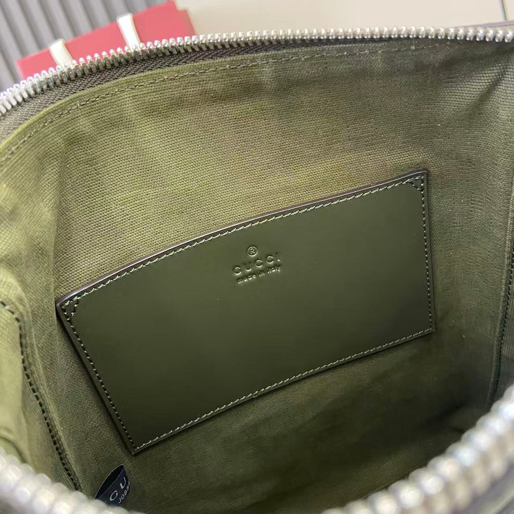 Crossbody bag interior lining with stitched leather patch and embossed logo