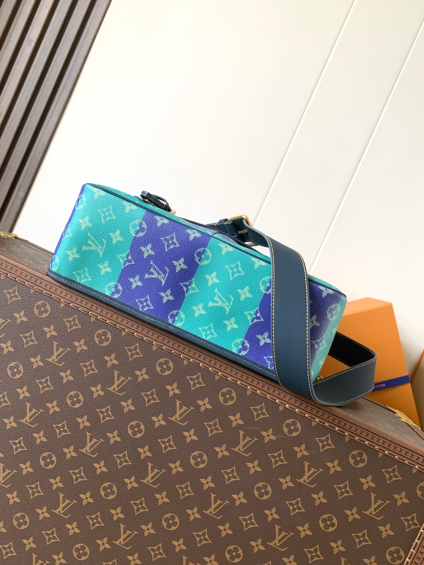 Louis Vuitton men's tote-style bag with multicolor monogram panels and blue handles
