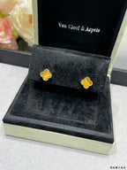 Van Cleef & Arpels clover stud earrings on black display cushion