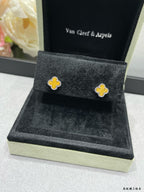 Van Cleef & Arpels clover stud earrings on black display cushion