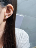 Clover stud earrings in gold tone on ear