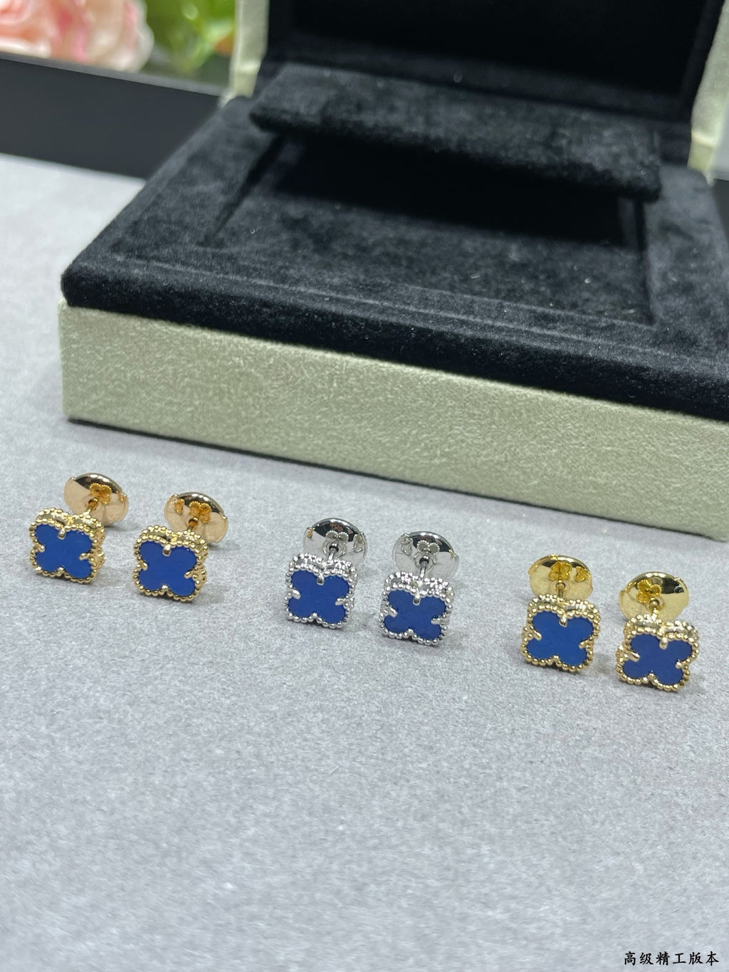 Clover enamel stud earrings with blue centers and gold-tone backs