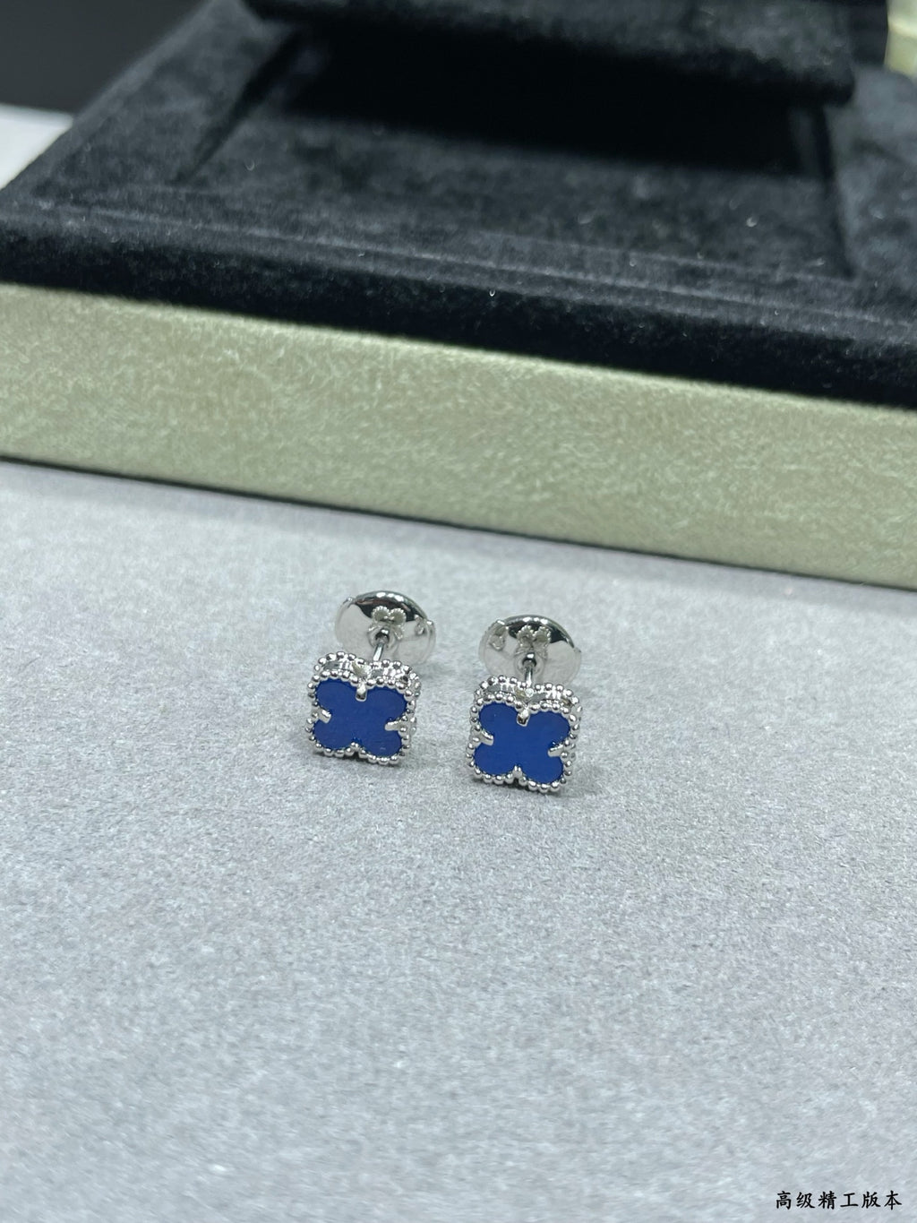 Clover enamel stud earrings with blue enamel and silver-tone posts in box