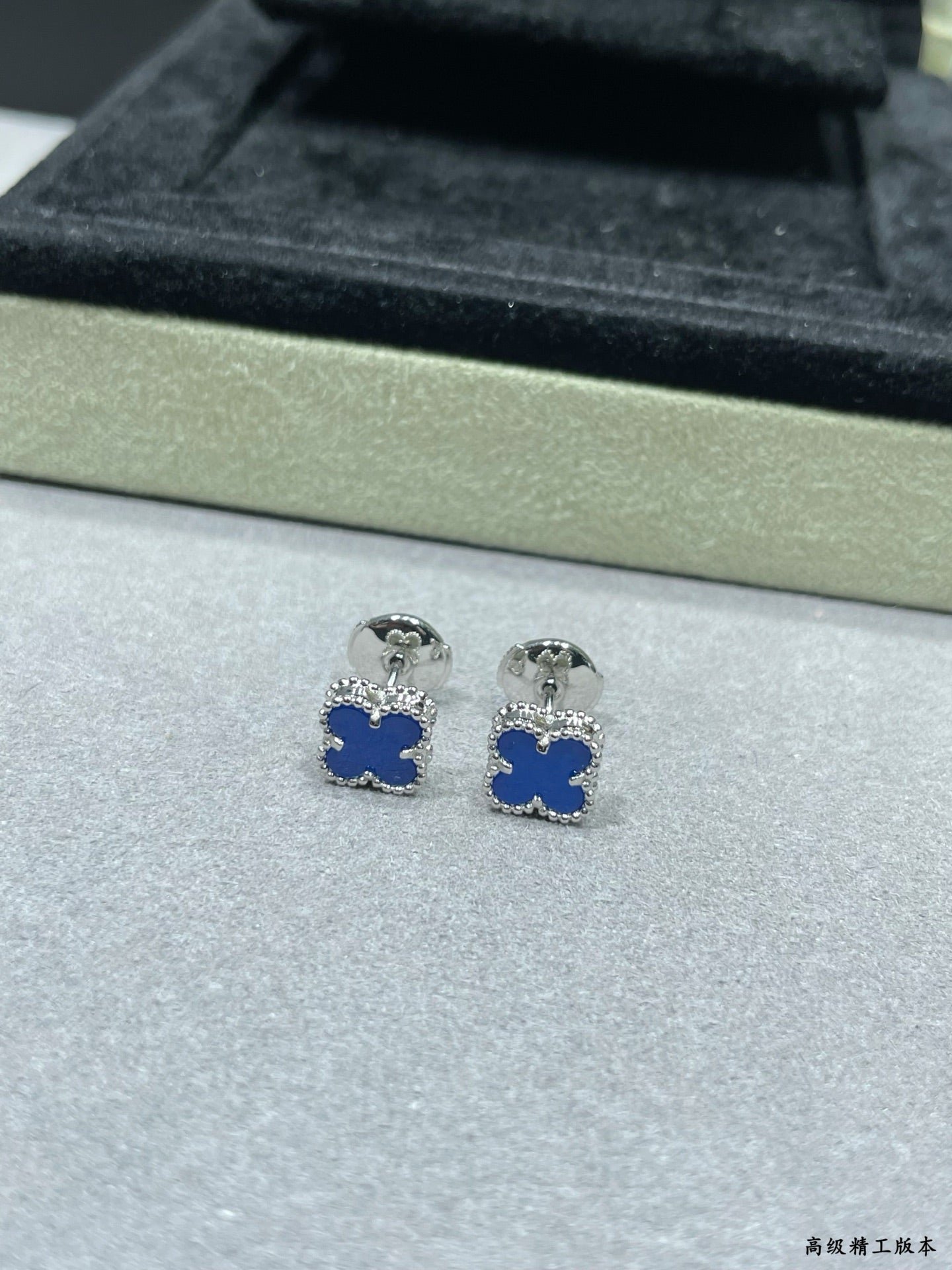 Clover enamel stud earrings with blue enamel and silver-tone posts in box