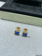Clover enamel stud earrings with blue centers and gold-tone posts in box