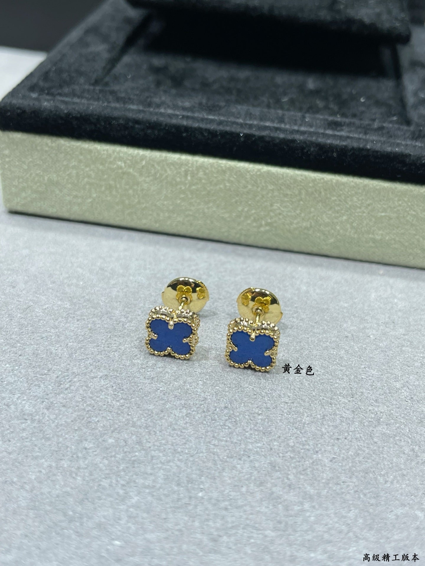 Clover enamel stud earrings with blue enamel and gold-tone posts in box