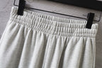 Balenciaga pants with elastic waist and pleated front view in light gray