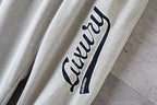 Balenciaga pants sleeve-style side graphic logo patch on light gray fabric