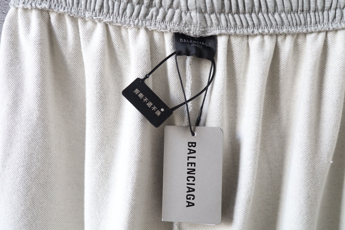 Balenciaga pants waist with hanging brand tags and elastic waistband