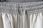 Balenciaga pants waistband with elastic drawstring casing on light gray fabric