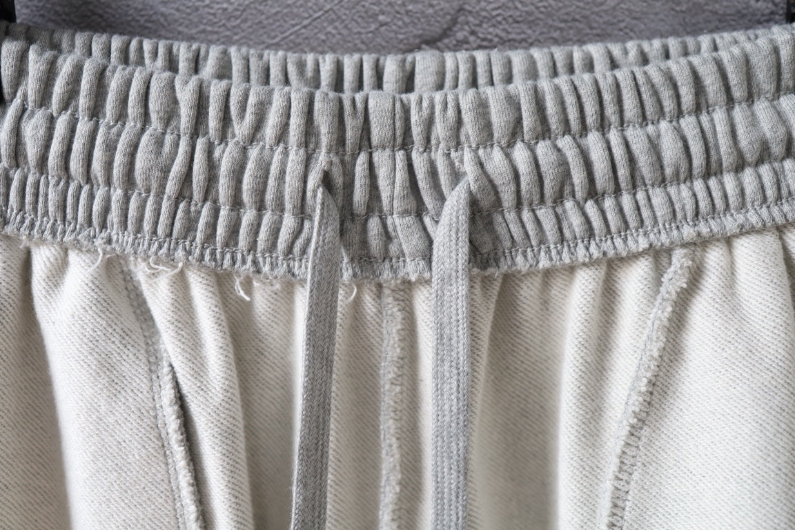 Balenciaga pants waistband with elastic drawstring casing on light gray fabric