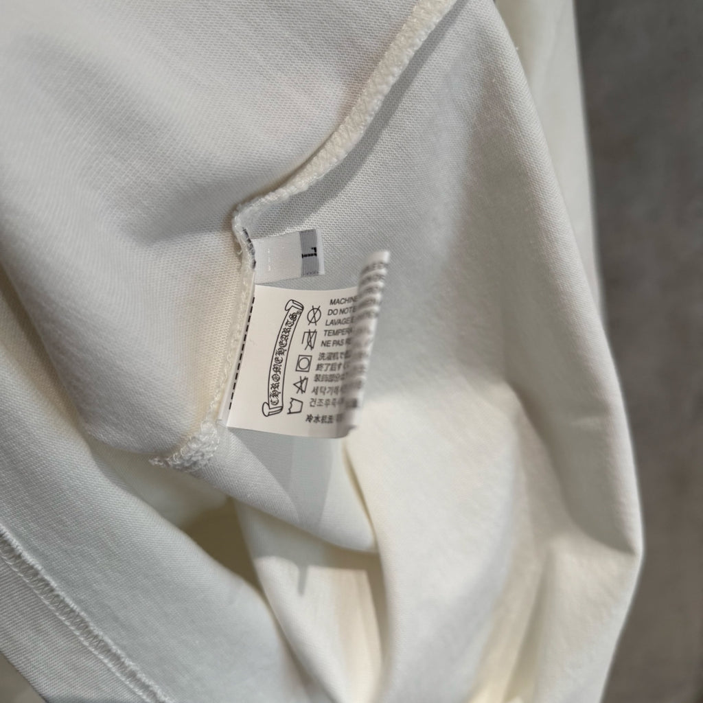 White long-sleeve T-shirt fabric and inner neck label close-up