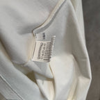 White long-sleeve T-shirt fabric and inner neck label close-up