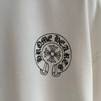 White long-sleeve T-shirt close-up of small circular chest logo