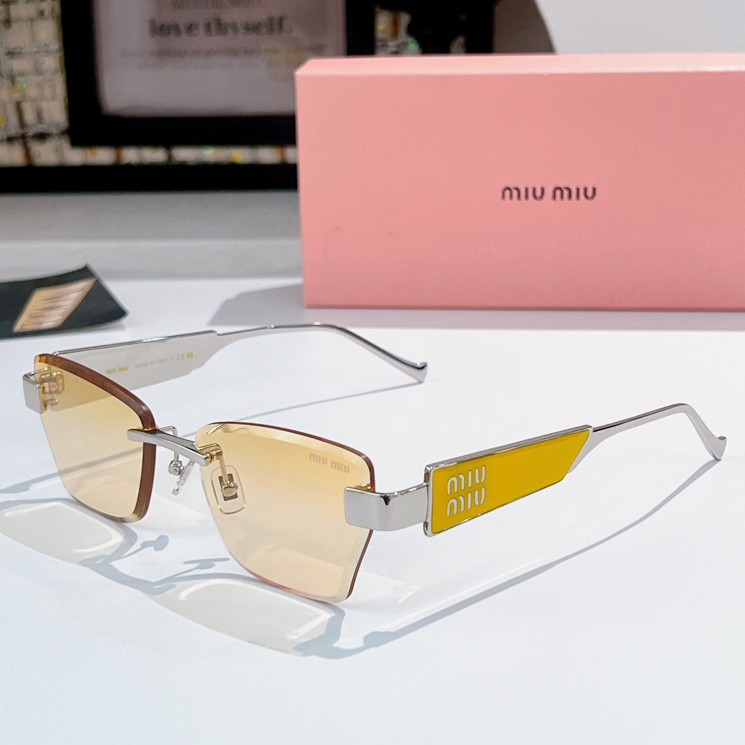 Glasses with gold-tone frames, warm brown tinted lenses, and miu miu logo temple