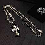 Two silver cross pendants with blue accents on linked chains