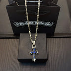 Silver cross pendant necklace with blue stone accents on a chain