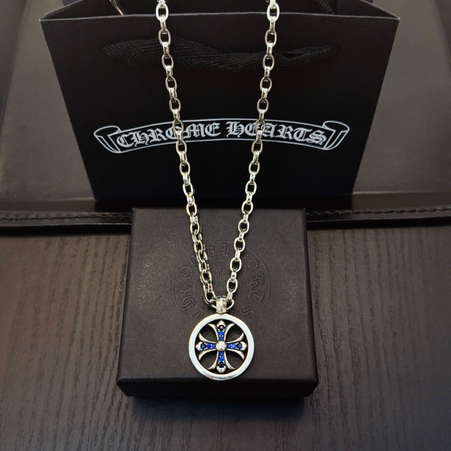 Round pendant necklace with blue center star on silver-tone chain