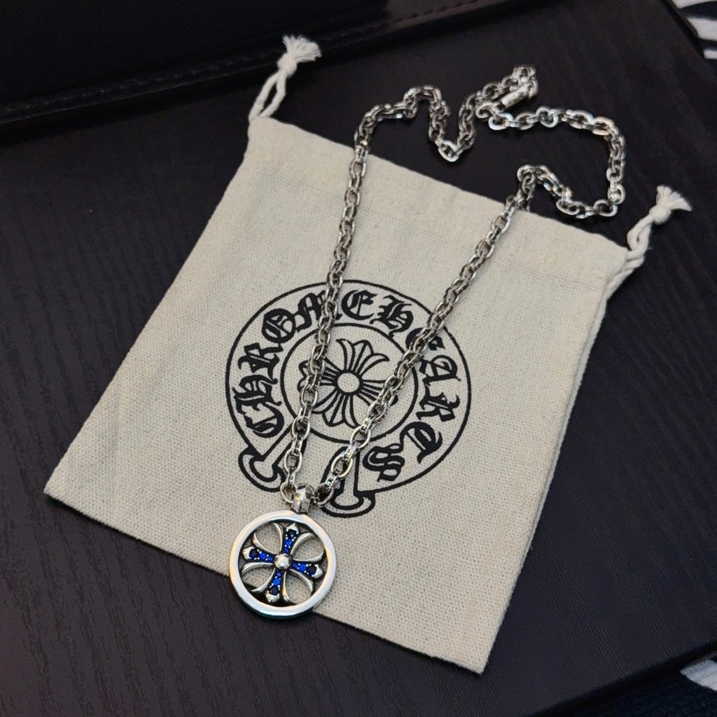 Round blue star pendant necklace with silver-tone chain in small pouch