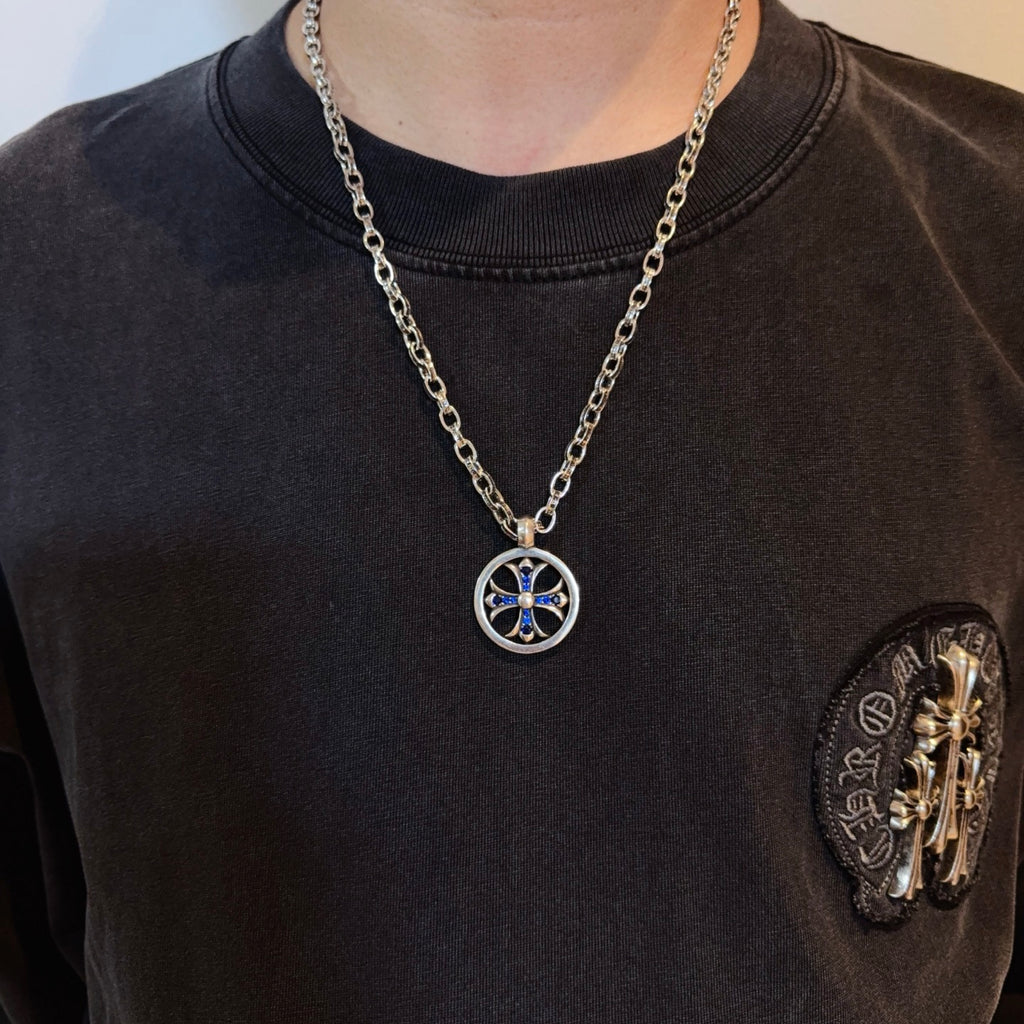 Round pendant necklace with blue star emblem on silver-tone chain