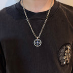 Round pendant necklace with blue star emblem on silver-tone chain