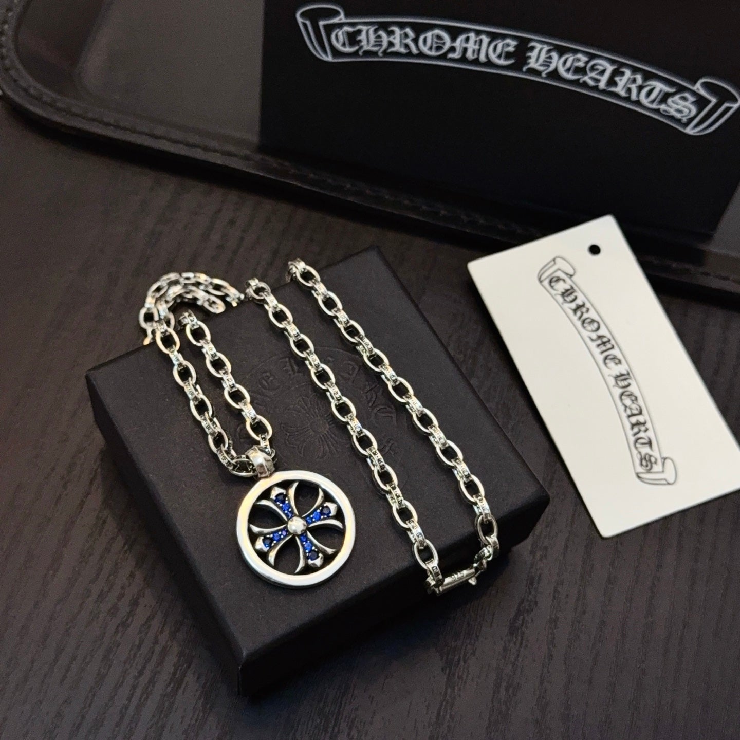 Silver-tone necklace with round blue star pendant and two chain links