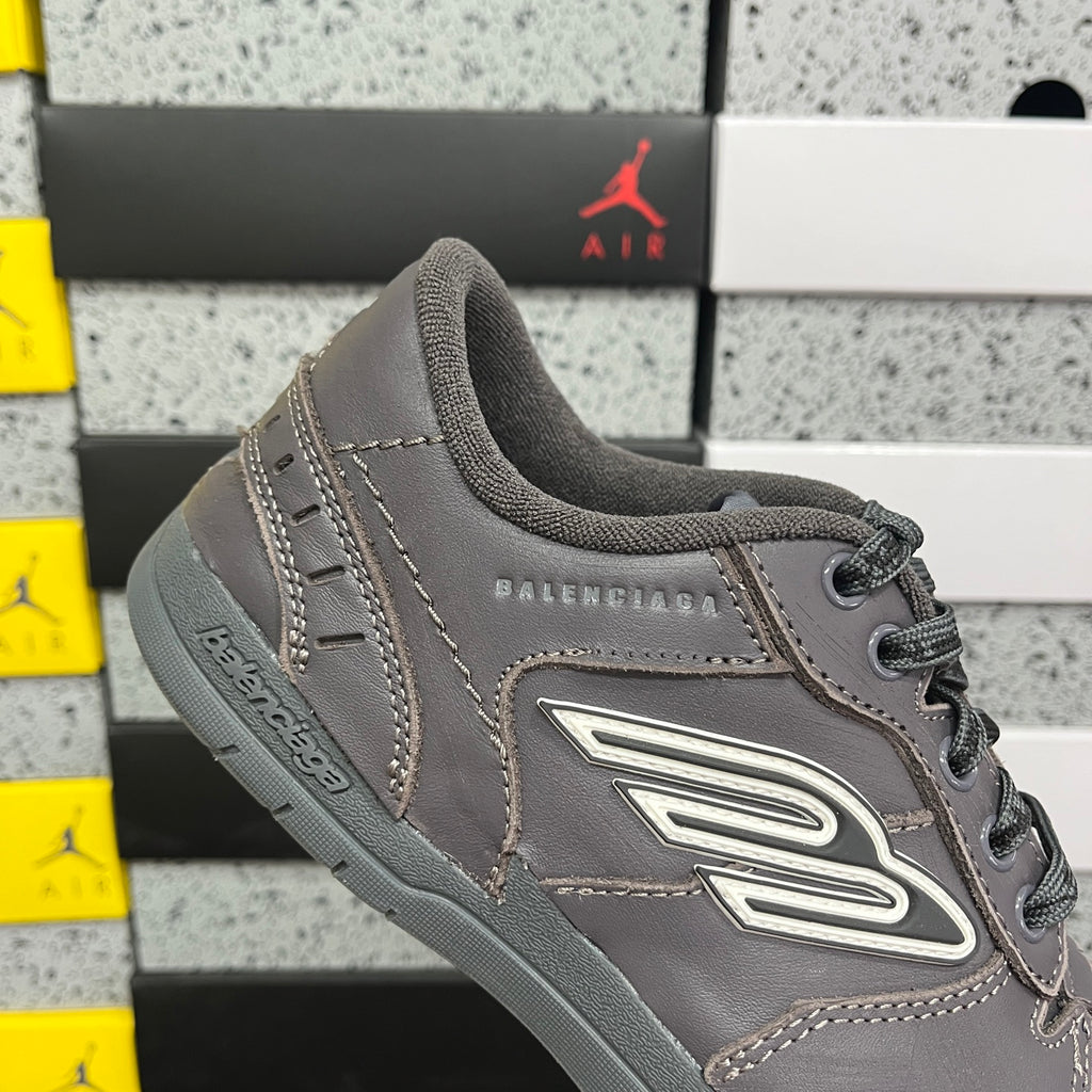 Grey Balenciaga lace-up sneaker with side logo patch and perforated trim