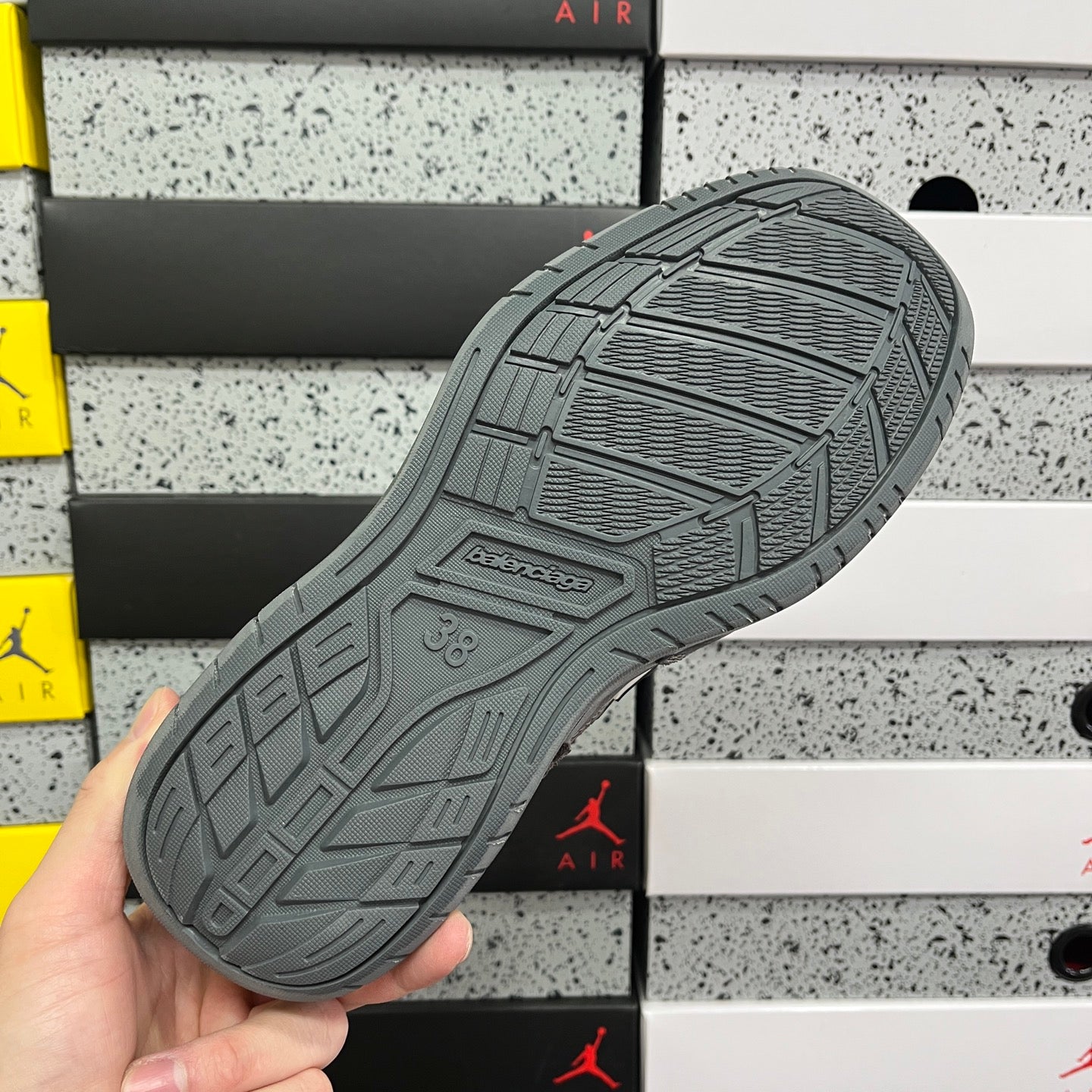 Grey Balenciaga sneaker outsole with tread pattern and embossed brand mark