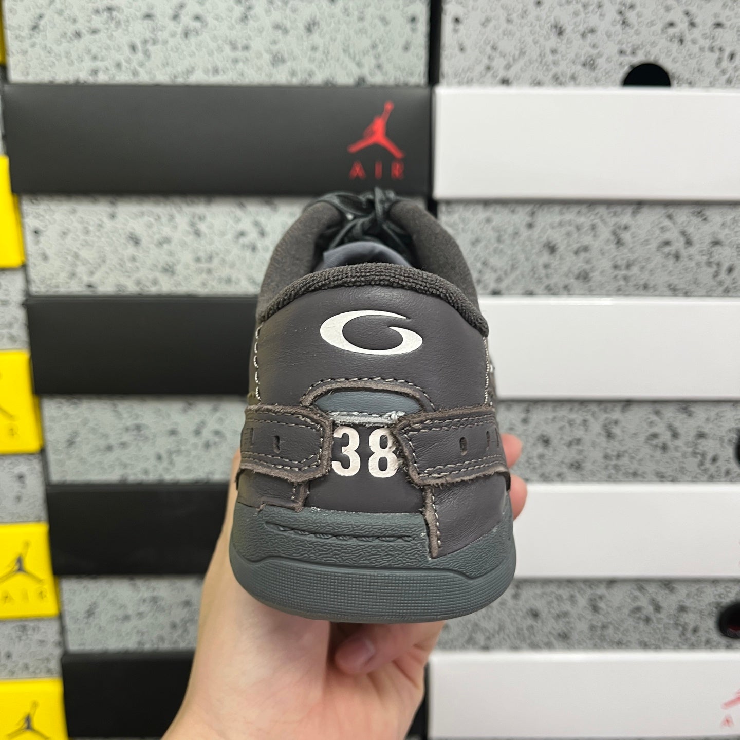 Grey Balenciaga sneaker heel with number 38 patch and padded back