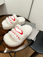 Sherpa slide sandals with red Balenciaga logo on white fuzzy straps