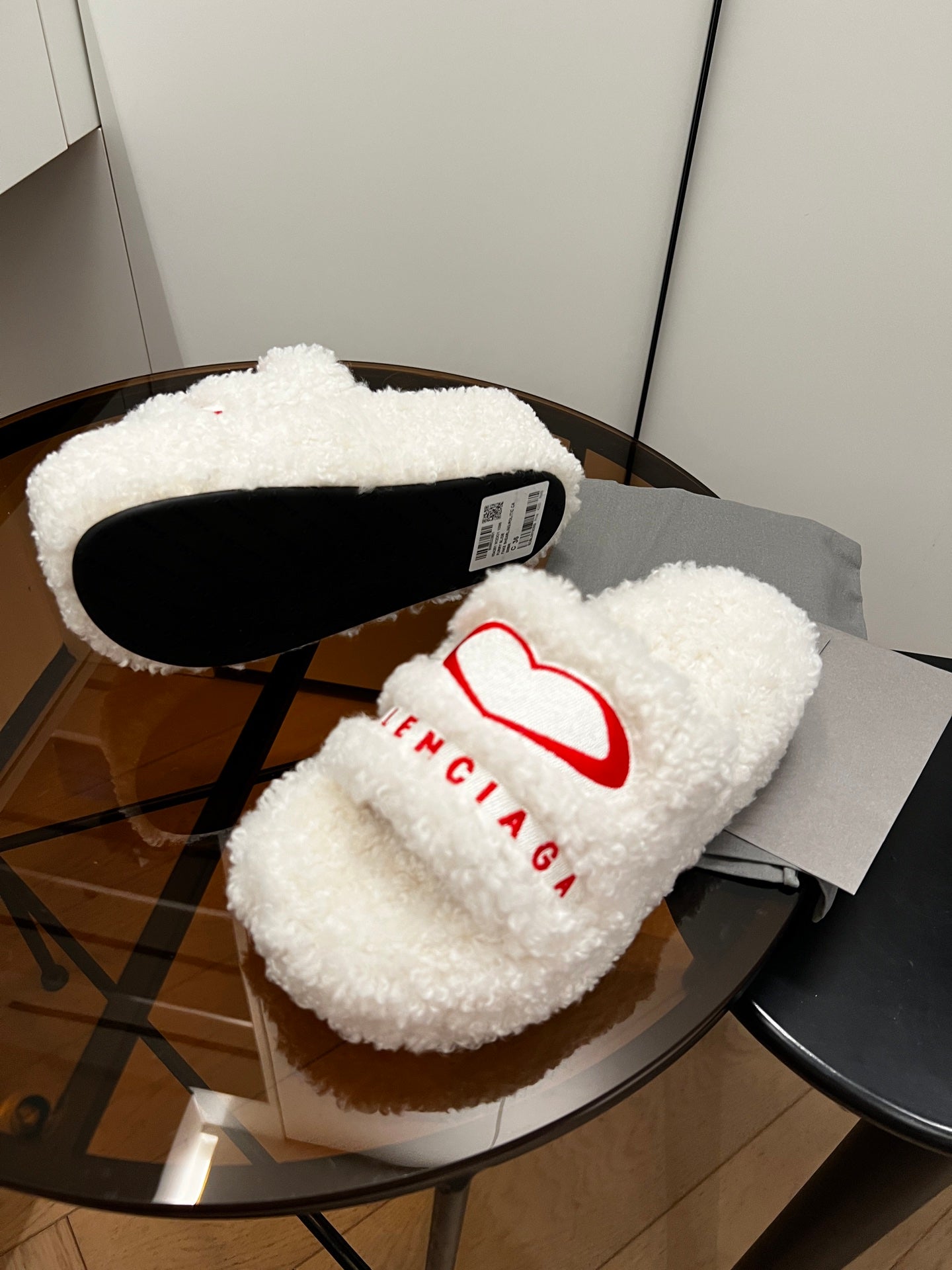Sherpa slide sandals with red logo and black sole interior, white fuzzy straps