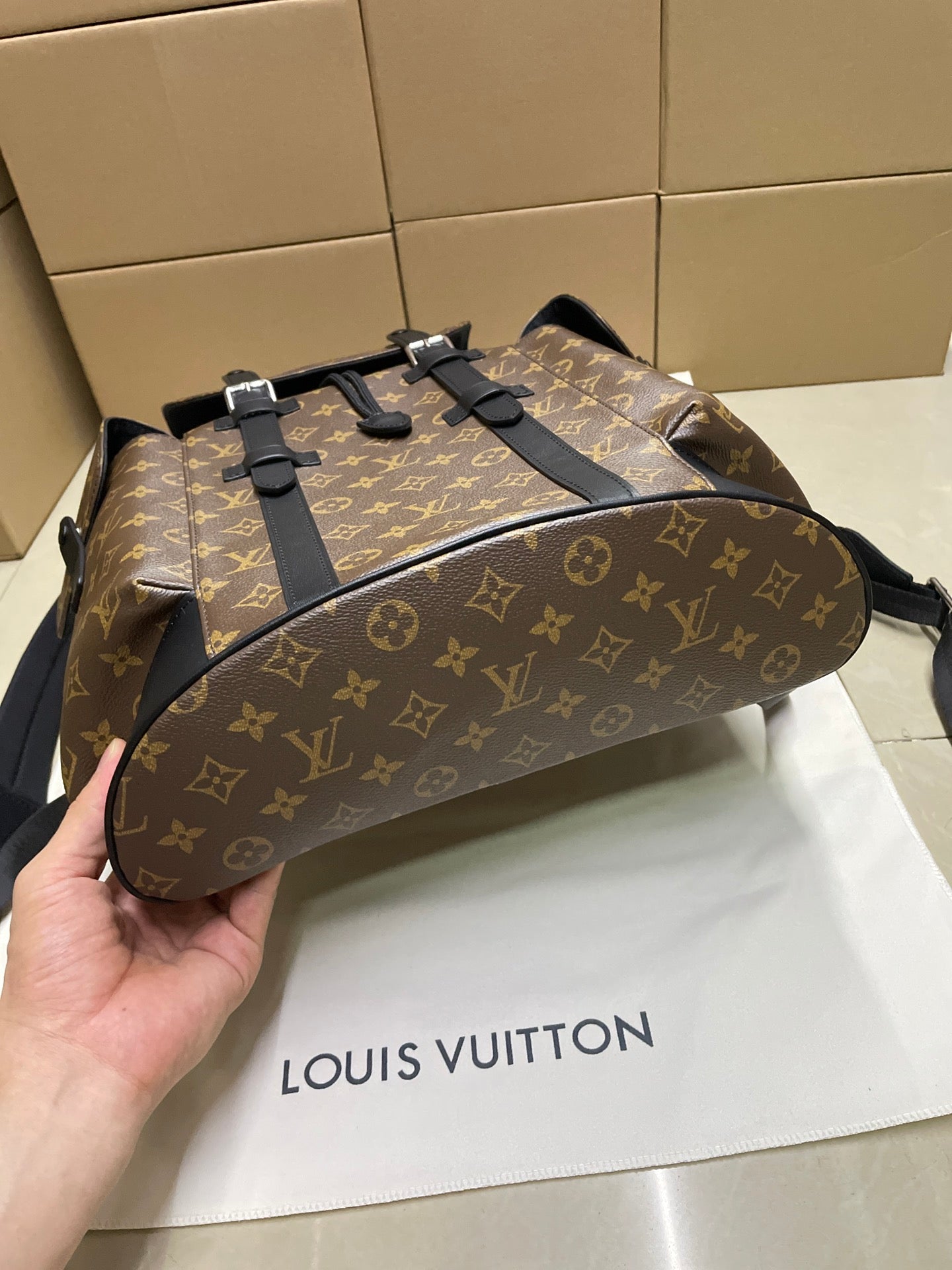 Monogram canvas Louis Vuitton duffel bag with black top straps and hardware