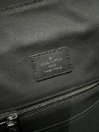 Louis Vuitton leather label patch with stitched edges on dark bag