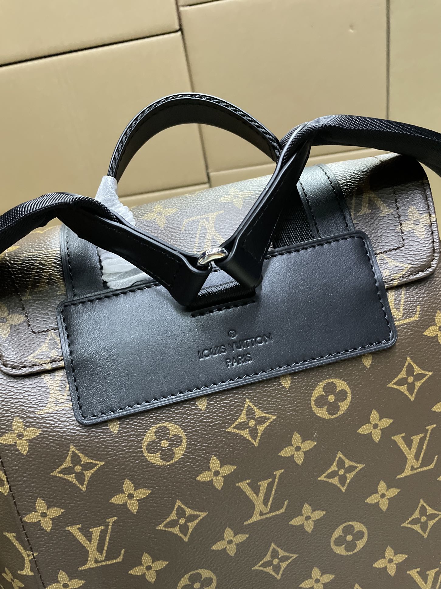 Louis Vuitton monogram bag with black leather top handle and stitched shoulder tab