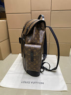 Monogram canvas Louis Vuitton backpack with side pocket and adjustable black strap