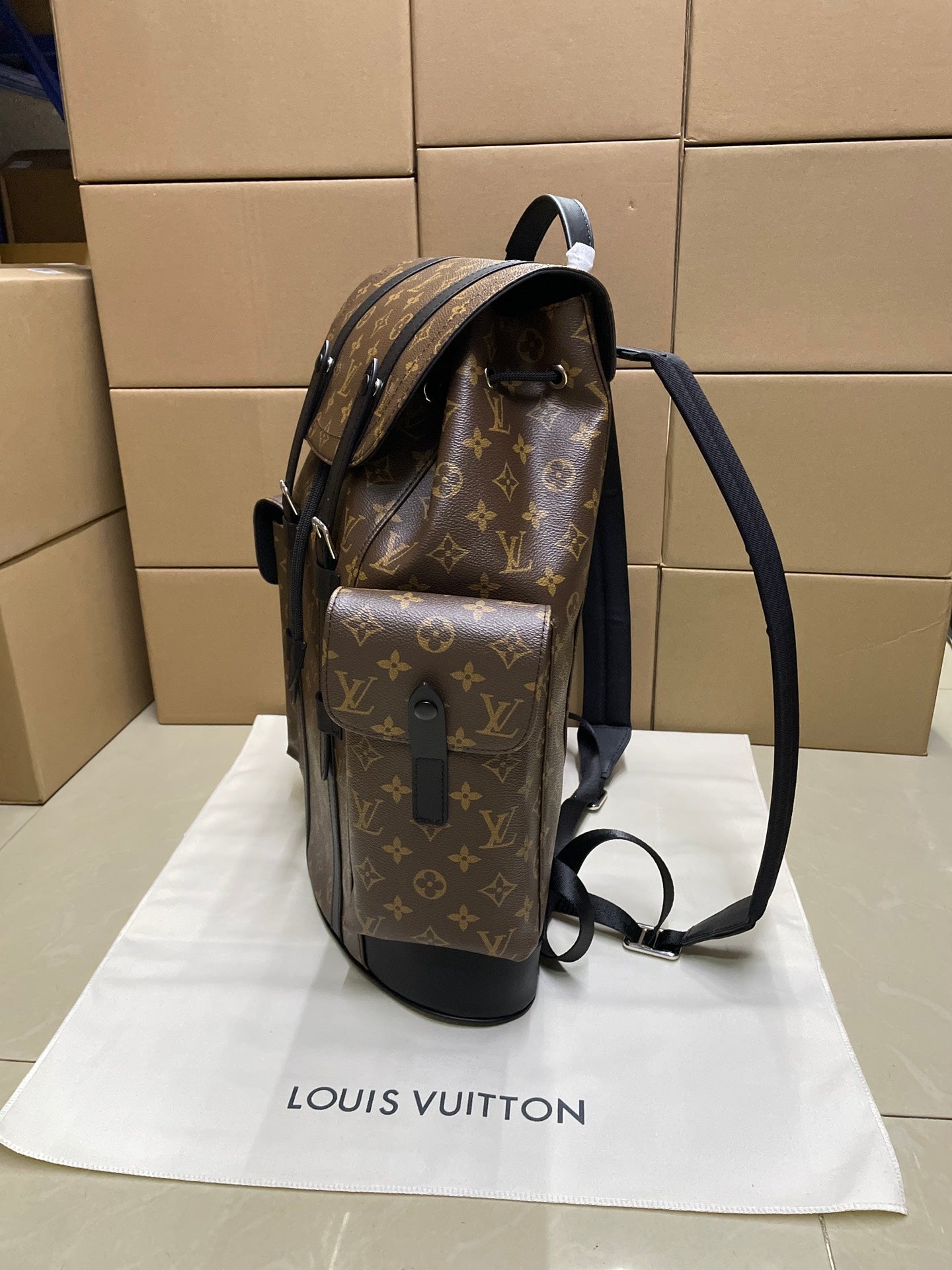 Monogram canvas Louis Vuitton backpack with side pocket and adjustable black strap
