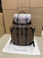 Louis Vuitton monogram backpack with dark leather straps and front buckle details