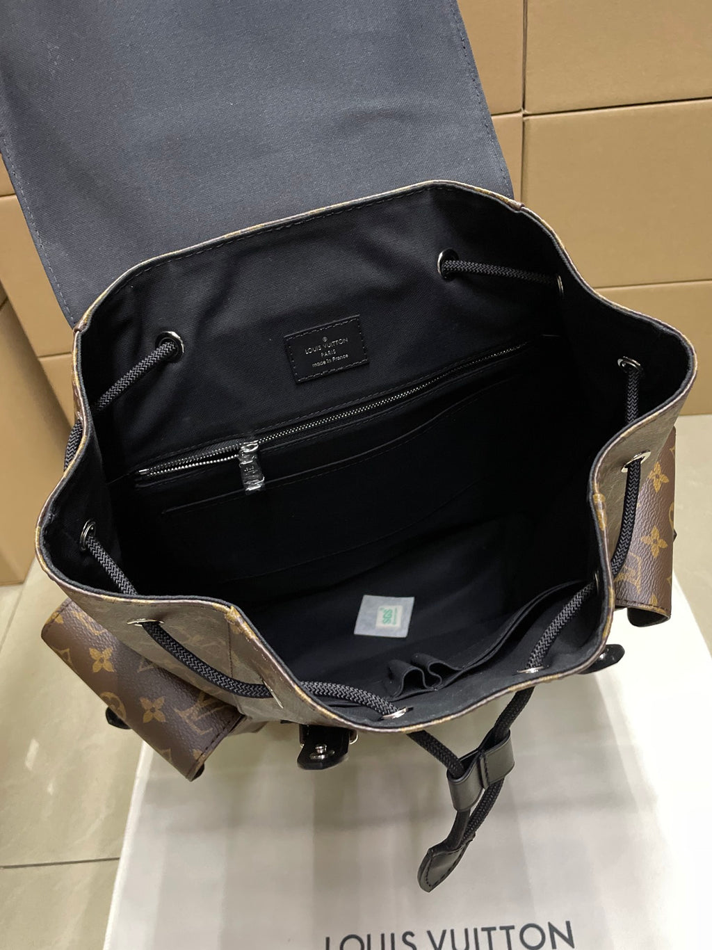 Louis Vuitton monogram backpack interior view with zip pocket and black lining