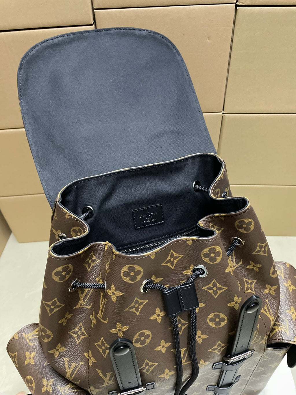 Monogram Louis Vuitton bucket-style bag with drawstring cords and black trim