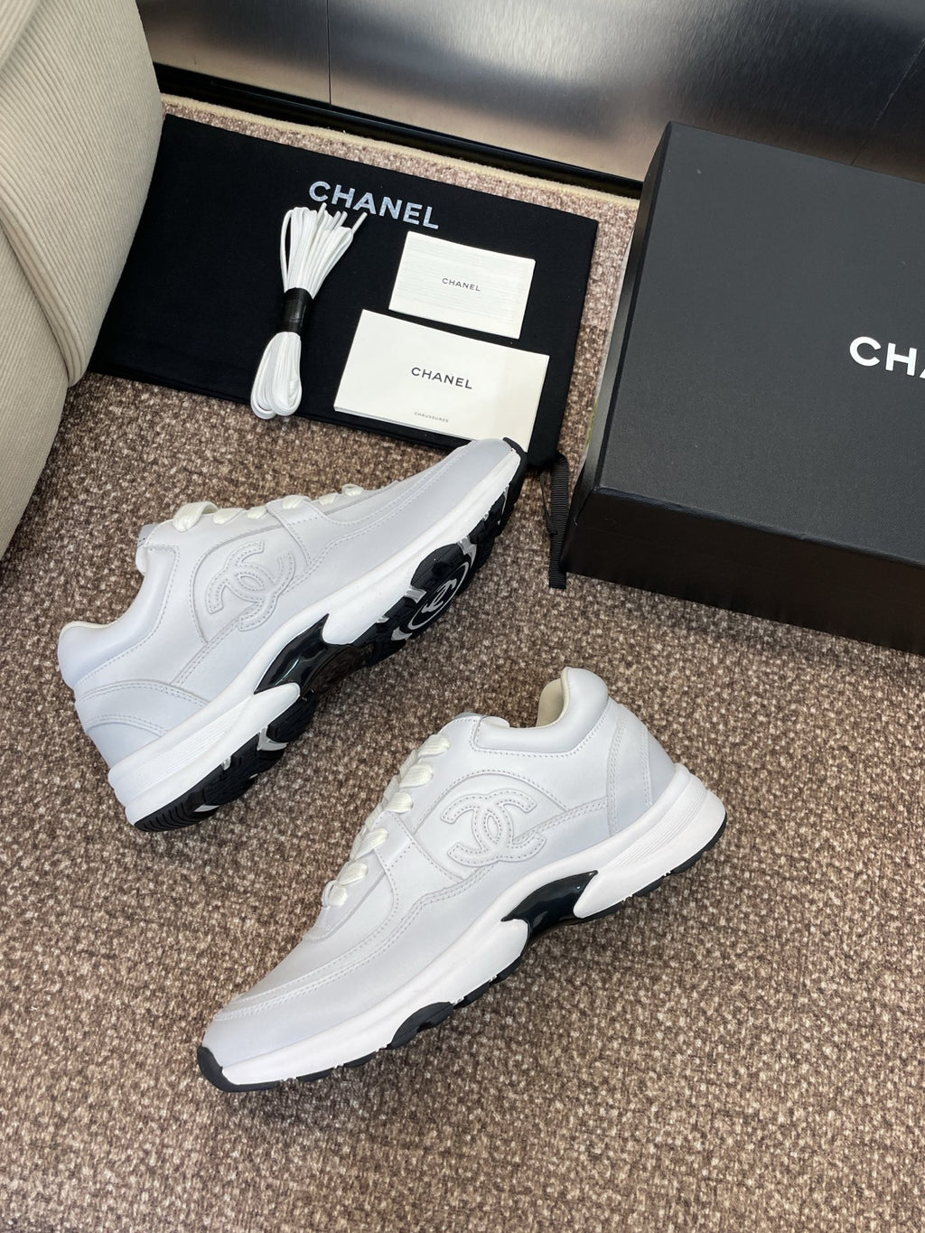 Chanel unisex white sneakers, two pairs with chunky soles on display