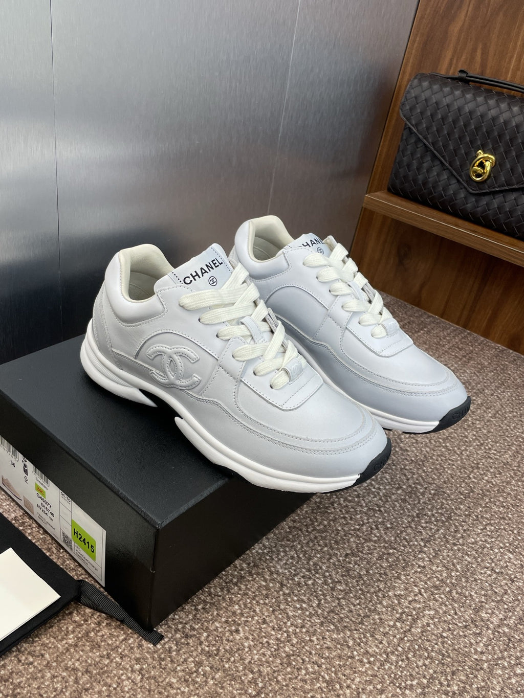 Chanel unisex white sneakers, side view pair with lace-up detail