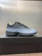 Unisex sneakers side view, light blue leather with Chanel CC logo and tread sole