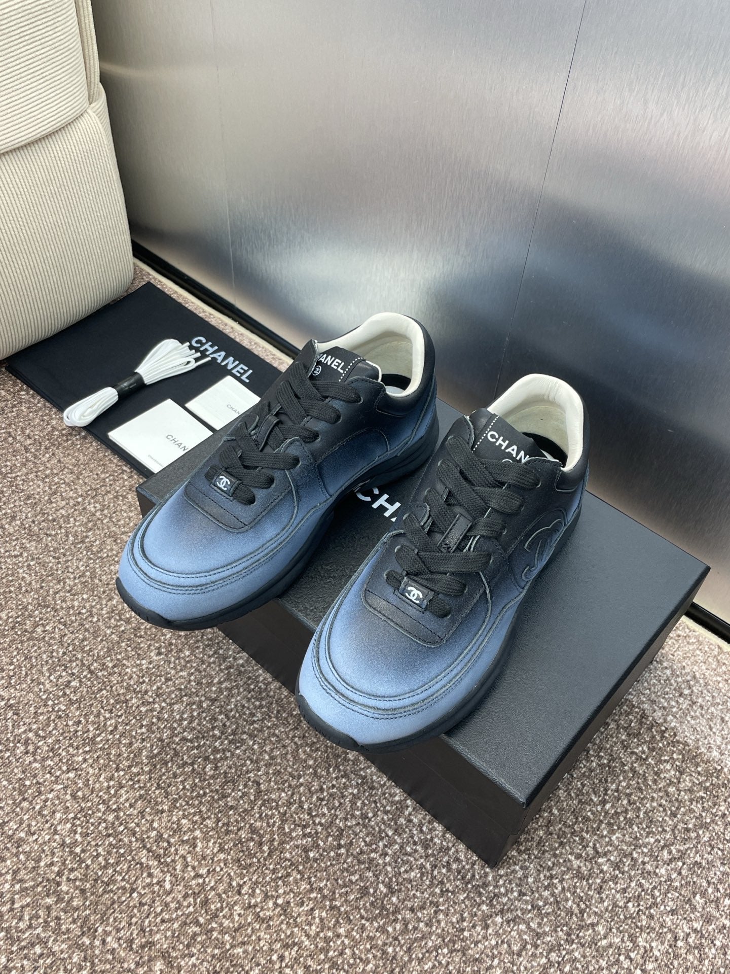 Unisex sneakers pair with Chanel CC logo, light blue leather and black laces