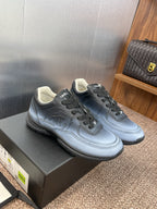 Unisex sneakers on box, light blue leather uppers with Chanel CC emblem