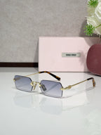 MiuMiu glasses with gold frame, blue tinted lenses, tortoise temple tips