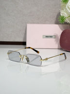MiuMiu glasses with gold metal frame and light blue tinted lenses
